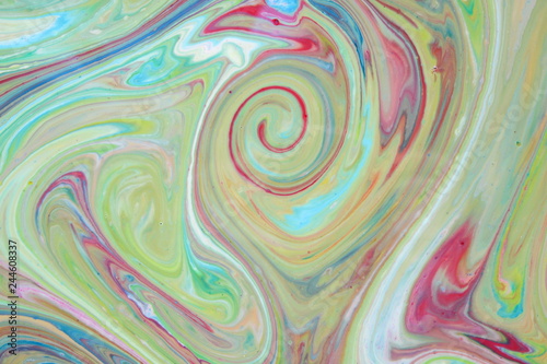 Abstract colorful background. Fine art in green color. Multicolored pattern on the liquid. Colored paint stains in the liquid. Art