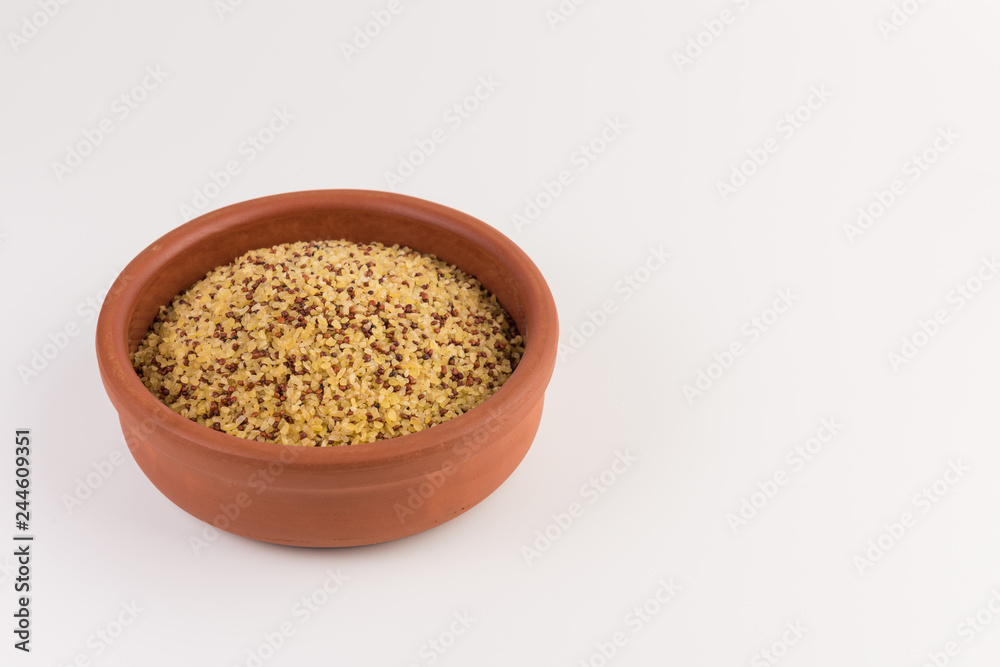 bowl of raw bulgur and quinoa isolated on white background bowl of raw bulgur and quinoa isolated on white background