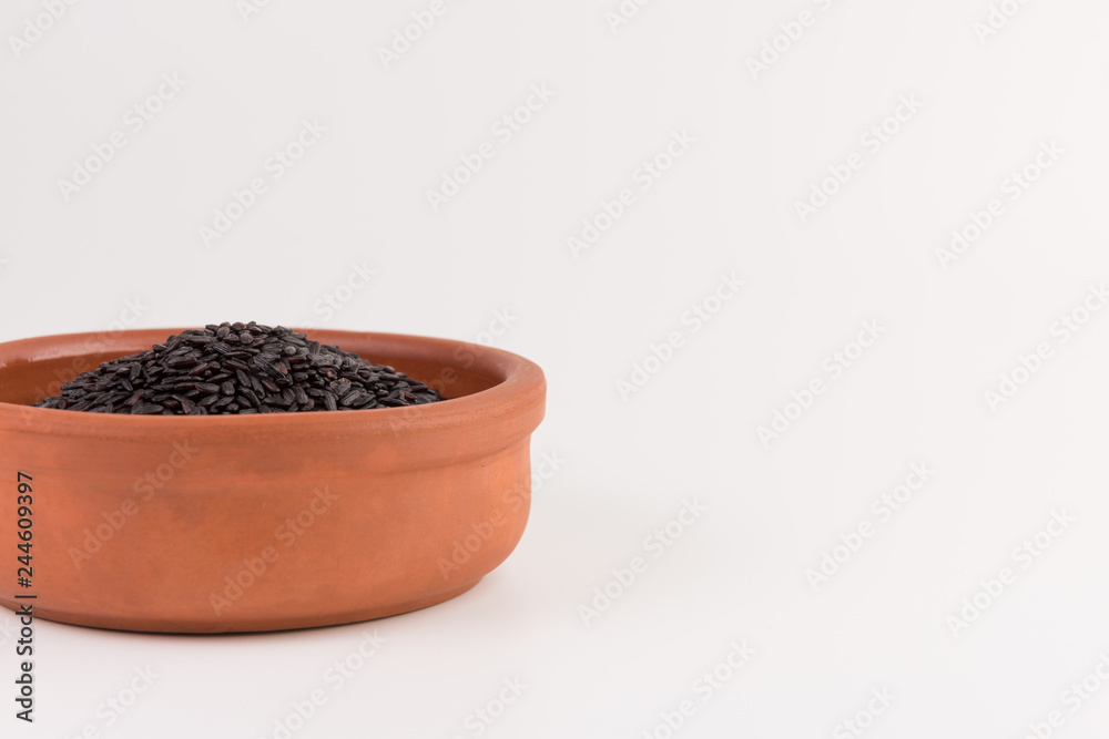 bowl of black wild rice isolated on white background bowl of black wild rice isolated on white background