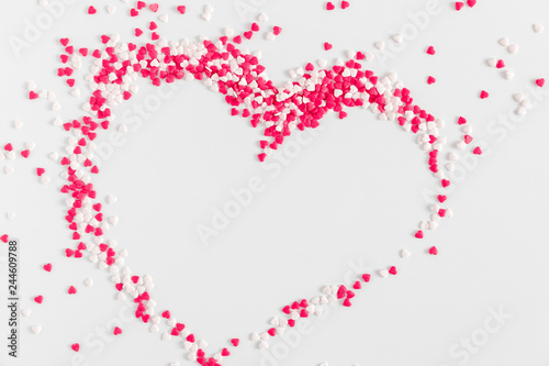 Valentine day concept  design. Small sugar decoration pattern on gray background. Flat lay  top view  copy space