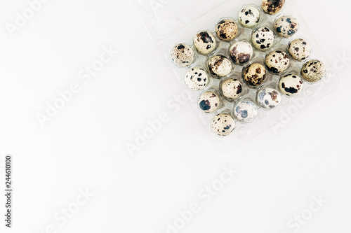 Uncooked quail eggs on white background top view, protein diet, healthy food concept. Flat lay, top view, copy space 
