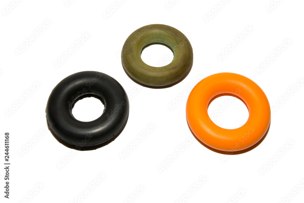 Means to strengthen the muscles of the hand. Expanders with different loads. Strength training. Multicolored expanders. Isolated on white background. Means to strengthen the muscles of the hand. Expanders with different loads. Strength training. Multicolored expanders. Isolated on white background.