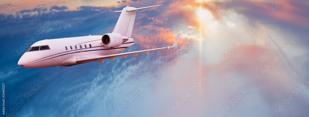 Naklejka premium Small private jetplane flying above beautiful clouds.