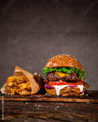 Tasty burger on wooden table.