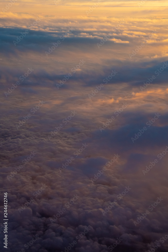 Cloud cover illuminated by sunset half orange and half in earth shadow Cloud cover illuminated by sunset half orange and half in earth shadow