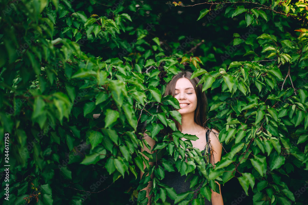 Portrait of happy pretty young teen girl in green leaves smiling healthy natural Portrait of happy pretty young teen girl in green leaves smiling healthy natural