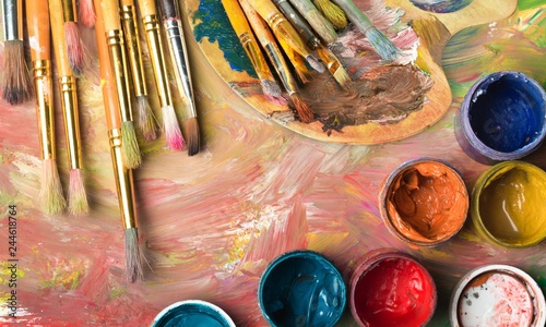 Composition of dirty painting brushes on colorful