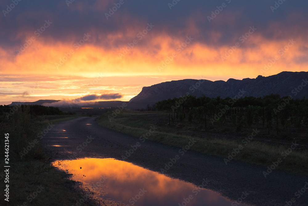 Coucher soleil Sainte victoire /sunset over holy victory after rain in provence with puddles of water Coucher soleil Sainte victoire /sunset over holy victory after rain in provence with puddles of water