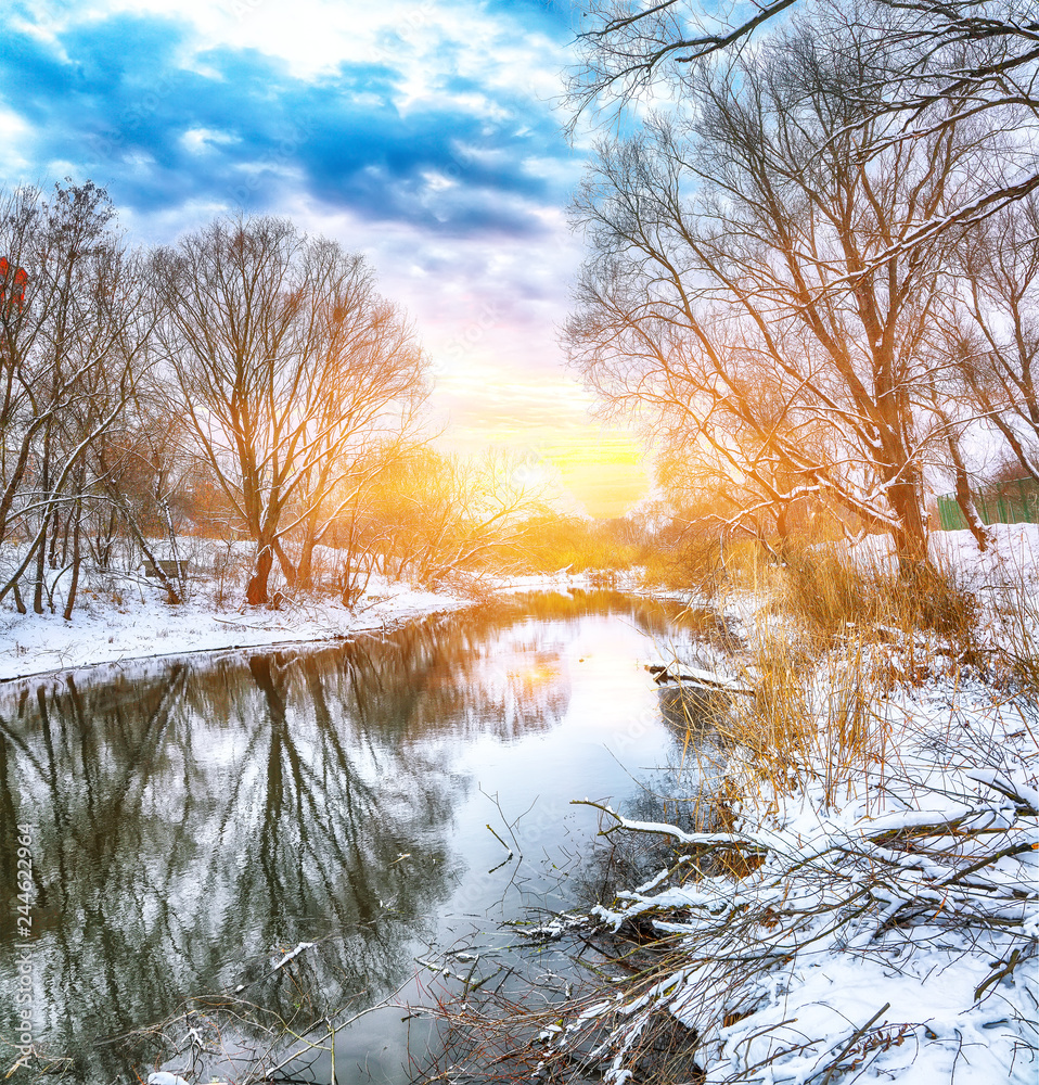 Winter landscape by a river in the sunset Winter landscape by a river in the sunset