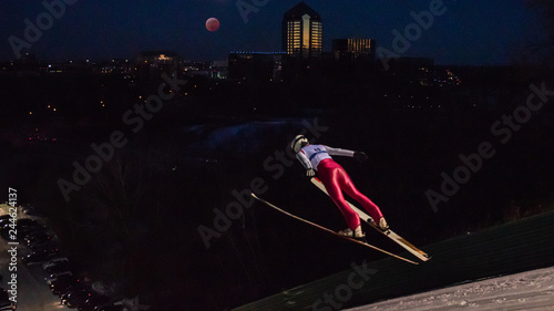 People are doing ski jump under the blood wolf moon