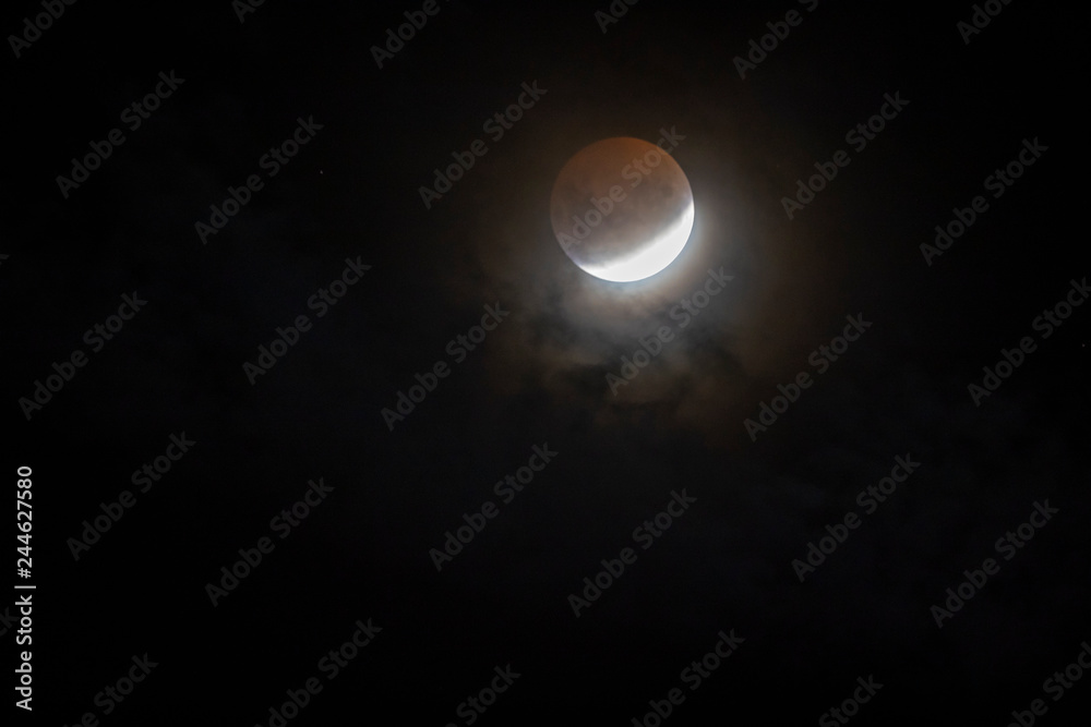 Red full Moon eclipse from Santiago de Chile city, a view from the southern hemisphere of this amazing astronomical event of the Earth shadow crossing the Moon surface and turning it red and yellow Red full Moon eclipse from Santiago de Chile city, a view from the southern hemisphere of this amazing astronomical event of the Earth shadow crossing the Moon surface and turning it red and yellow