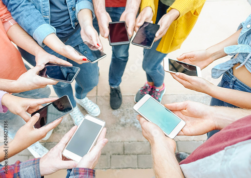 Group of friends using their smart mobile phones - Millennial young people addicted to new technology trends - Concept of people, generation z, tech, social media network and youth lifestyle
