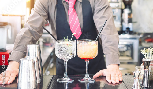 Young bartender making cocktails at bar counter - Barman serving drinks - Work, passion and mixologist concept