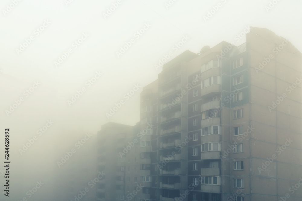 Heavy morning fog and evaporation in the city with high-rise buildings