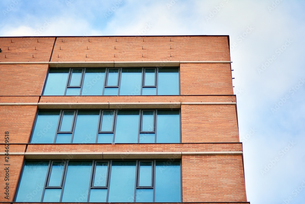 Facade fragment of a modern office building. Exterior of glass wall with abstract texture. Facade fragment of a modern office building. Exterior of glass wall with abstract texture.