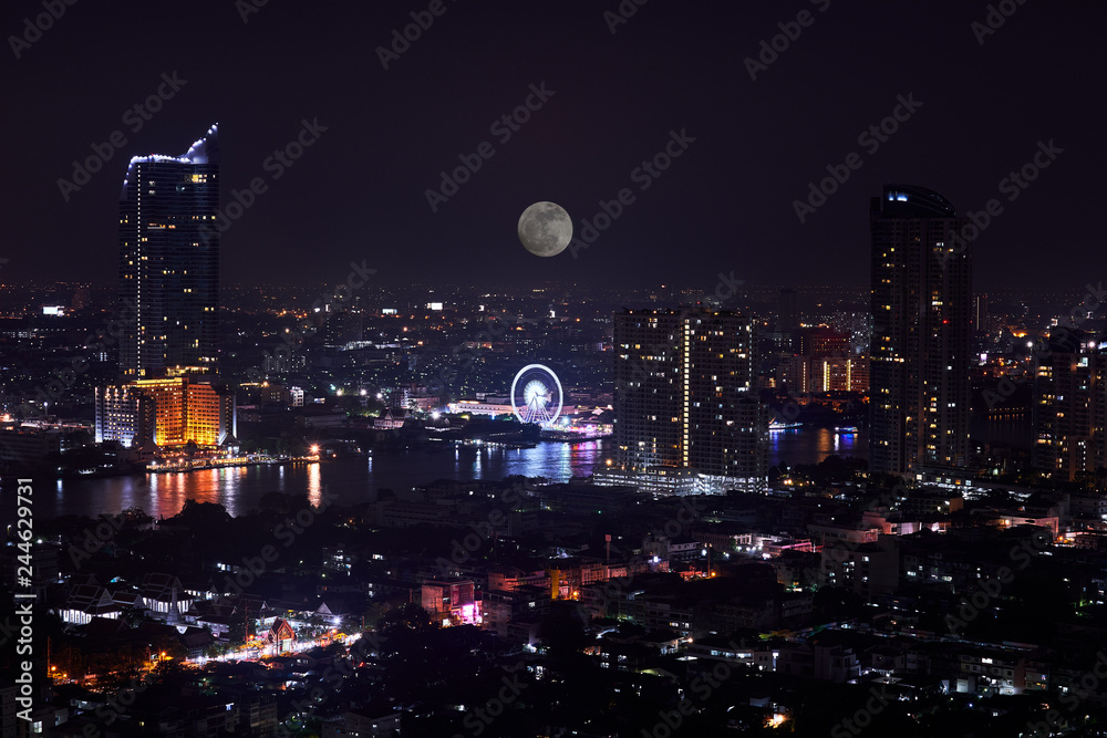 night cityscape with full moon and river