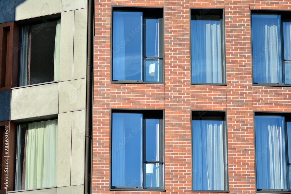 Modern apartment buildings on a sunny day with a blue sky. Facade of a modern apartment building