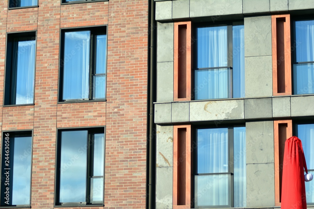 Modern apartment buildings on a sunny day with a blue sky. Facade of a modern apartment building Modern apartment buildings on a sunny day with a blue sky. Facade of a modern apartment building