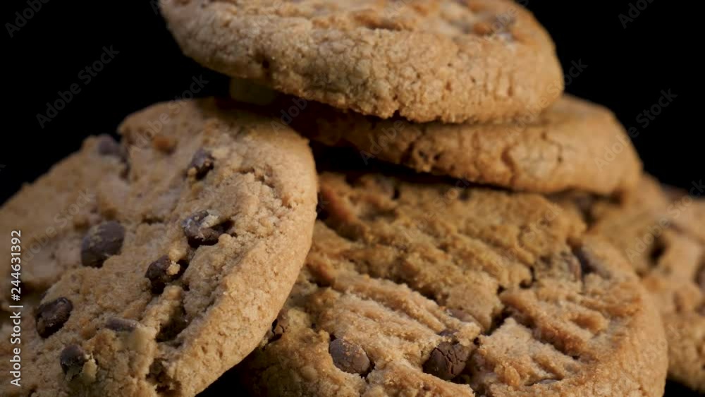 Close up of Freshly baked cookies with chocolate rotate against black background