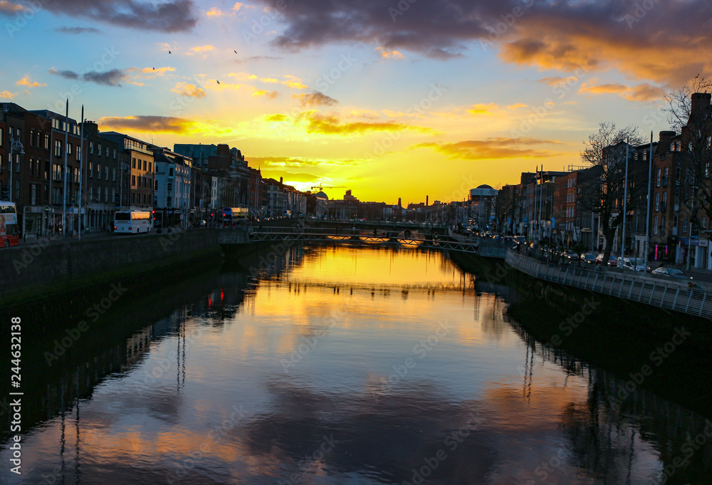 Dublin night scene with Ha'penny bridge and Liffey river lights 