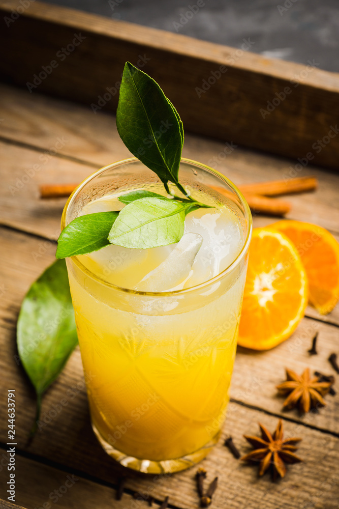 Fototapeta premium Fresh cocktail with mandarines on the rustic background. Selective focus. Shallow depth of field.