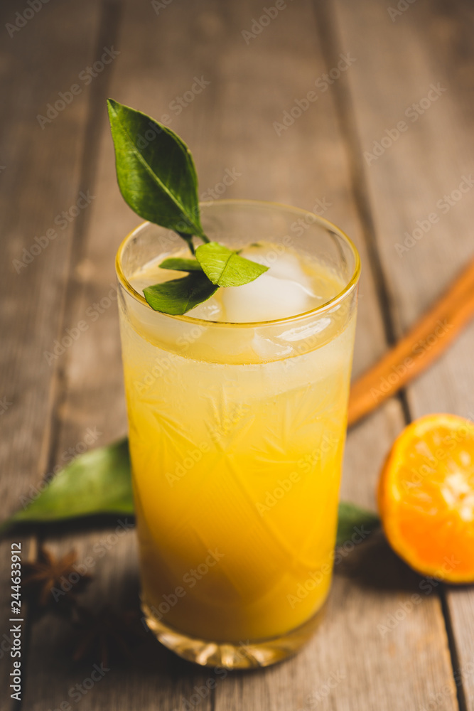 Fototapeta premium Fresh cocktail with mandarines on the rustic background. Selective focus. Shallow depth of field.