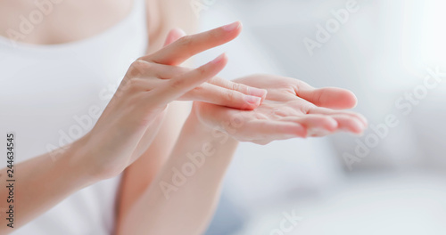 woman apply moisturizer in hand photo