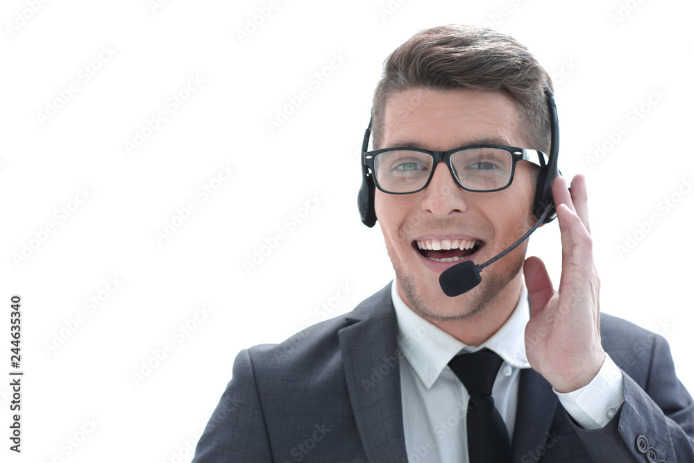 Smiling businessman using headset when talking to customer Smiling businessman using headset when talking to customer