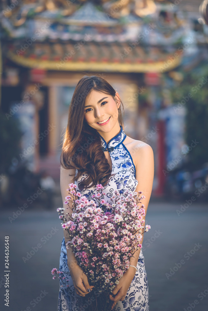 Beautiful woman with cheongsam traditional Chinese dress on Chinese new year. Beautiful woman with cheongsam traditional Chinese dress on Chinese new year.