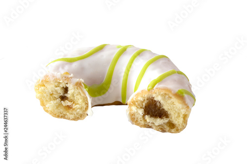 Half eaten doughnut with yellowstripes isolated on white photo