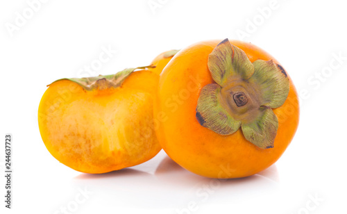 Tropical fruit persimmon. Kaki with leaves on white background