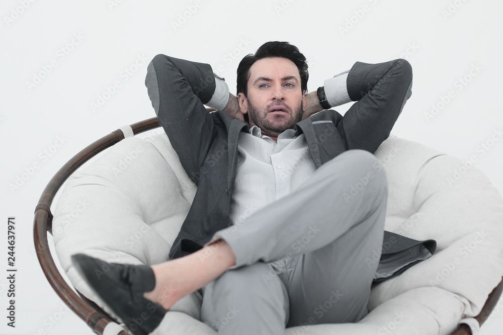 close up.thoughtful modern man sitting in a comfortable chair close up.thoughtful modern man sitting in a comfortable chair