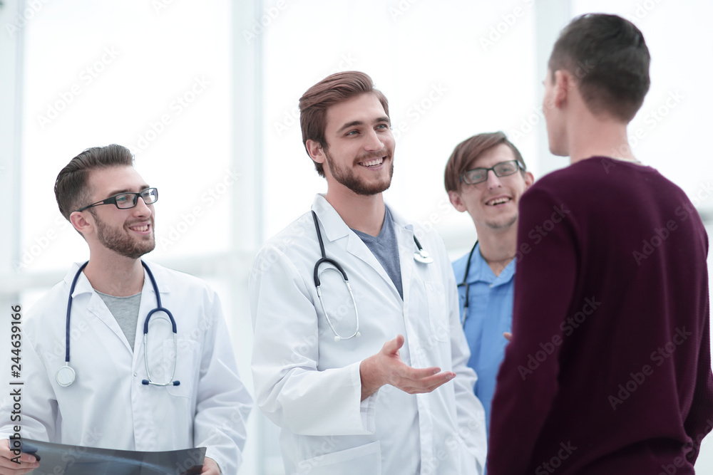 handsome doctor talking with the patient handsome doctor talking with the patient