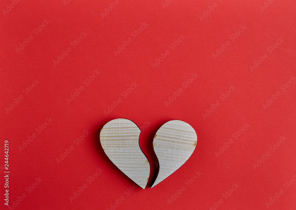 Fototapeta premium Wooden heart shape on red paper