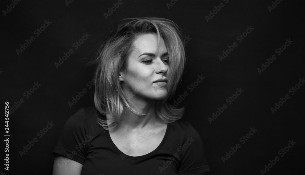 Dramatic black and white portrait of a beautiful woman on a dark background Dramatic black and white portrait of a beautiful woman on a dark background