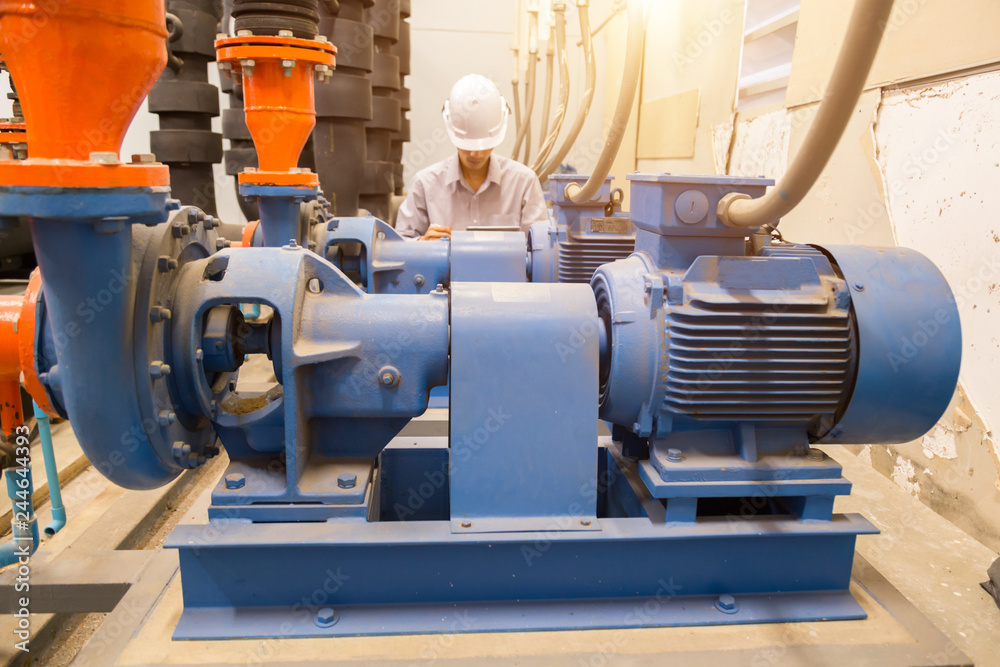 Asian engineer maintenance checking technical data of system equipment Condenser Water pump and pressure gauge , water pump. Asian engineer maintenance checking technical data of system equipment Condenser Water pump and pressure gauge , water pump.