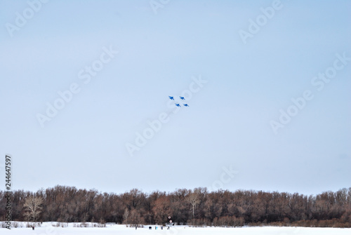 Performance of aerobatic team Russian Knights at the air show..Omsk, Russia - 19 March, 2016: Performance of Russian Knights at the air show..