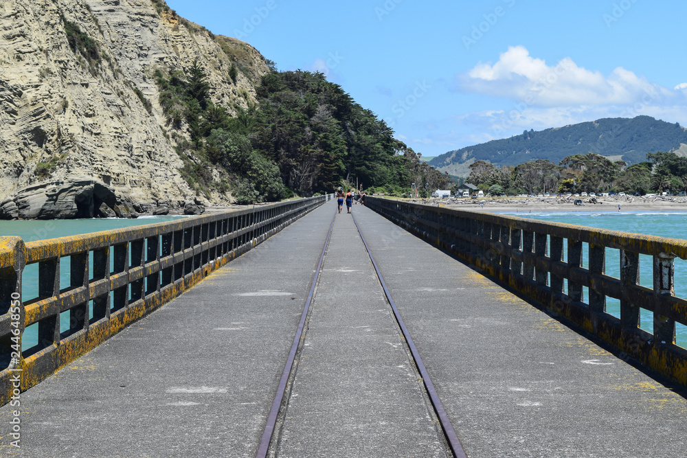 Romantic couple walking along the pier at Tolaga Bay, New Zealand. Romantic couple walking along the pier at Tolaga Bay, New Zealand.