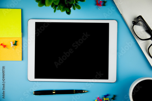 top view with blank mock up tablet on Office desk working space.