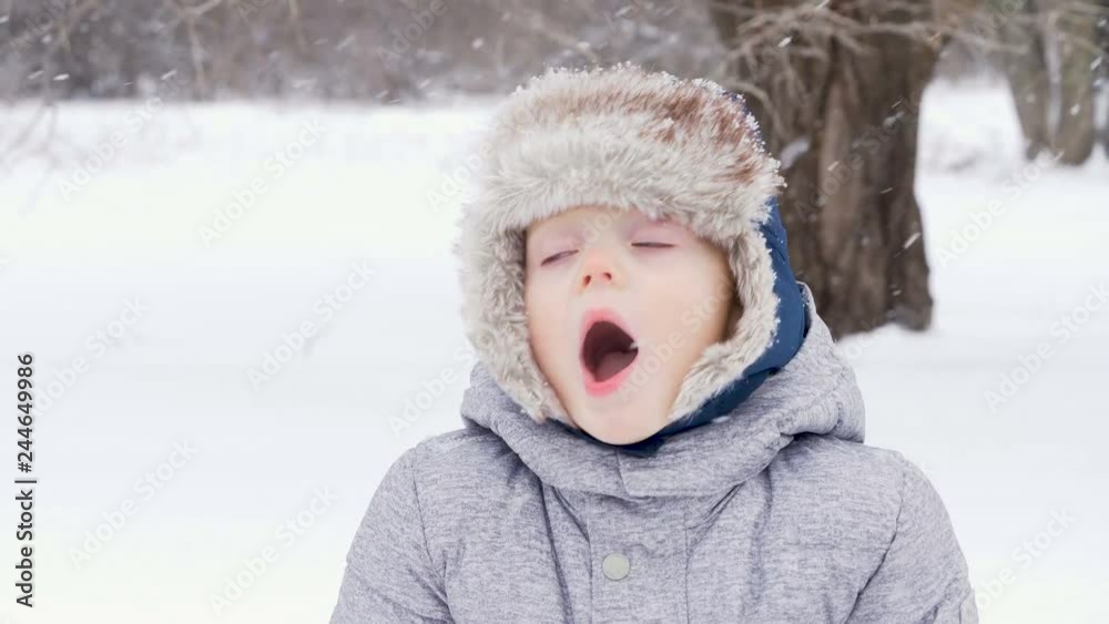 Cute little boy kid playing with toy truck and snow in winter. two years old child