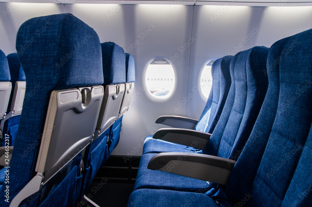 Fototapeta premium Interior view of economy coach seats inside of passenger airplane