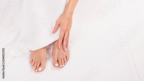 Female feet on terry towel. Top view. Skin care concept.