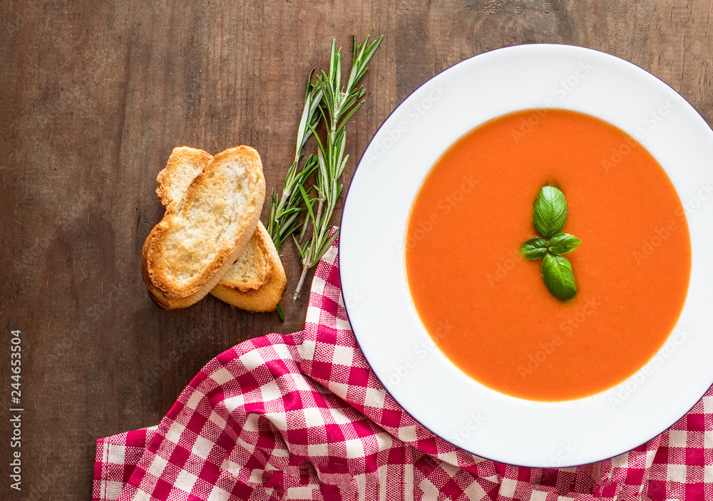 Vegetarian autumn Tomato soup with bread on wooden table, flat lay. Copy space Vegetarian autumn Tomato soup with bread on wooden table, flat lay. Copy space