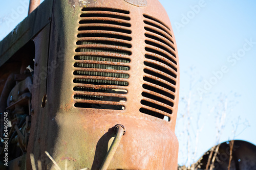 runt on old tractor in the field