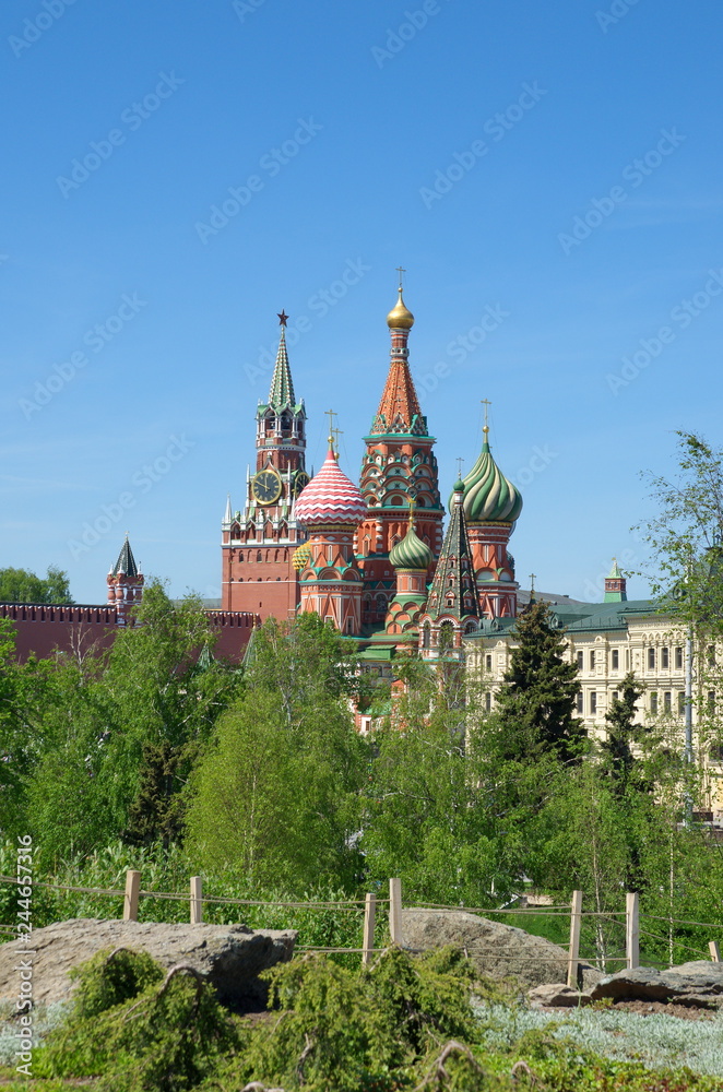 Moscow, Russia - may 12, 2018: Spring view of Pokrovsky Cathedral (St. Basil's Cathedral) and the Spasskaya tower of the Moscow Kremlin from Zaryadye landscape Park