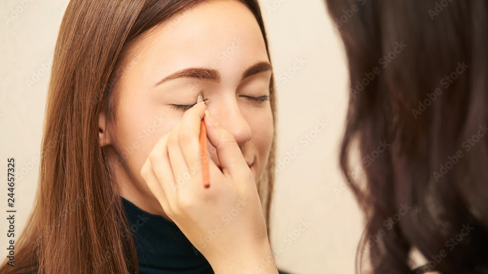 Makeup professional artist apply face mascara. Woman beauty model. Nature nude look. Contour foundation Makeup professional artist apply face mascara. Woman beauty model. Nature nude look. Contour foundation