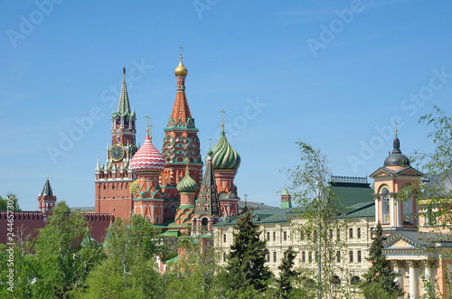 Spring view of the Intercession Cathedral (St. Basil's Cathedral) and the Spasskaya tower of the Moscow Kremlin on a Sunny spring day. Moscow, Russia