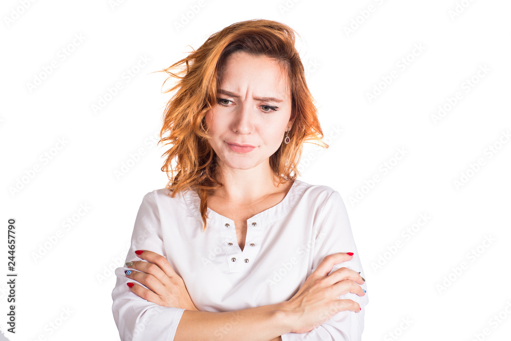 Portrait of an upset young casual brunette woman standing with arms folded isolated over white background. Portrait of an upset young casual brunette woman standing with arms folded isolated over white background.