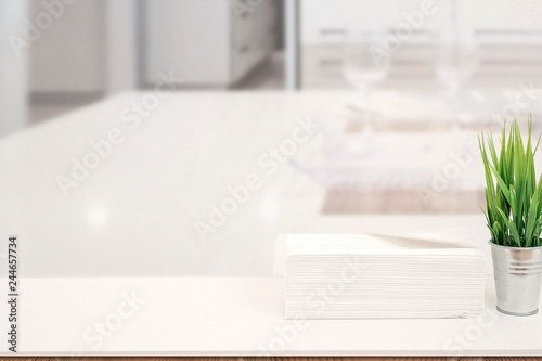 Mockup stack of paper towels on white table indoors with copy space © NAMPIX