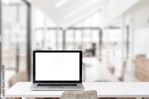 Fototapeta Naklejka Na Ścianę i Meble -  Mock up blank screen laptop on white  table in co-working space.